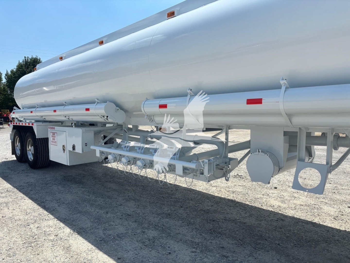 Tank trailer side view showing cylindrical tanker with undercarriage and mounting hardware