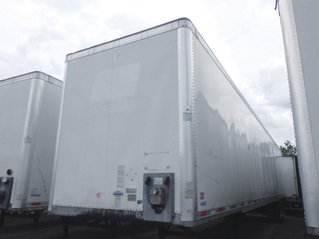Trailer side and rear showing a Vanguard aluminum box trailer with raised riveted panels and front corner jack.