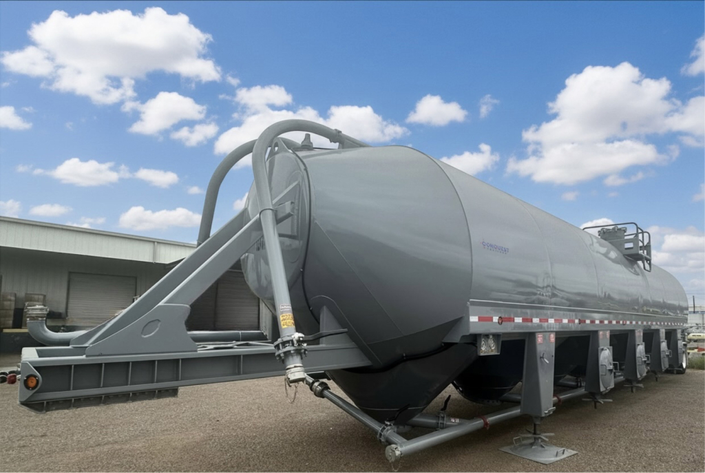 Conquest cement silo trailer in serviceable condition showing large cylindrical tank on dual-axle trailer with piping and support stands.