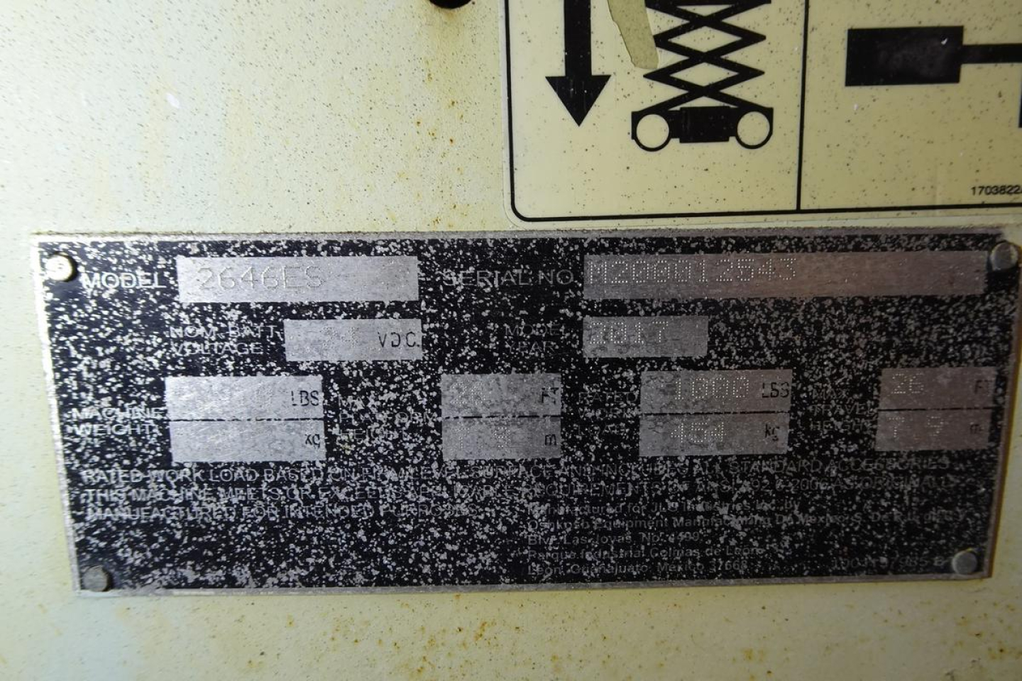 JLG 2646ES scissor lift nameplate close-up showing model and serial numbers and ratings plate.