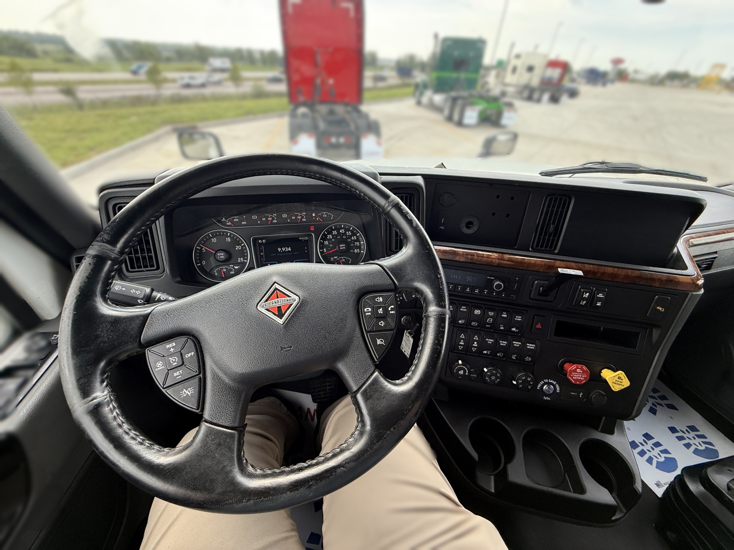 Truck cab interior showing steering wheel, dashboard, and center console of a 2022 International LT625 sleeper truck.