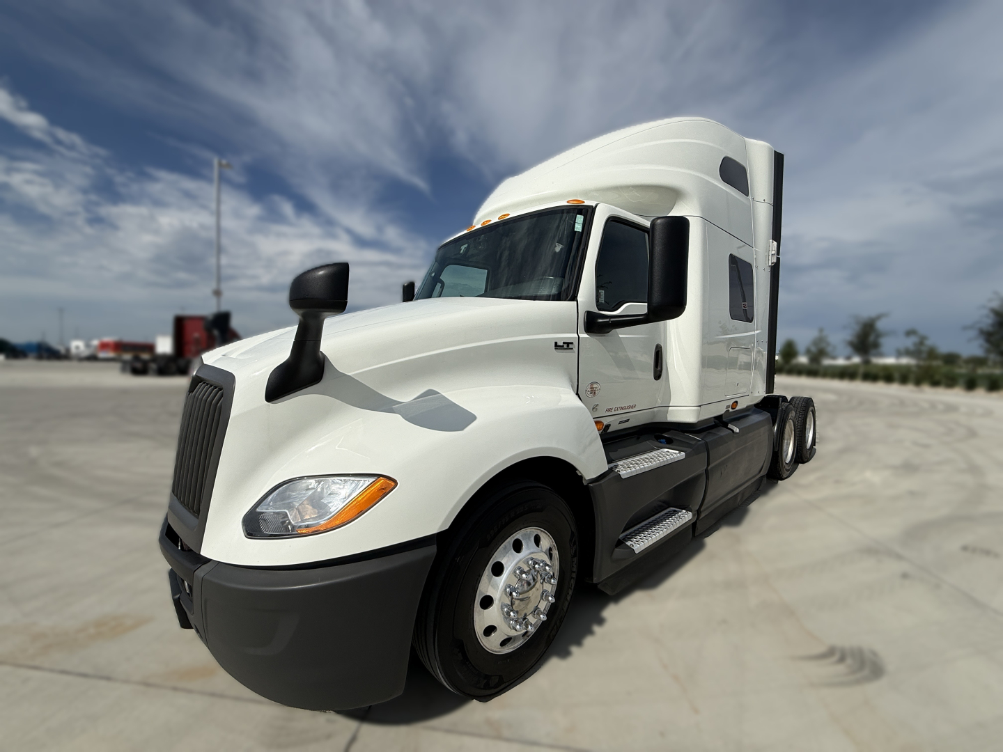 White 2022 International LT625 tractor truck, front-left view in a lot; no visible text on side or cab; clean chassis with black bumper and steps.