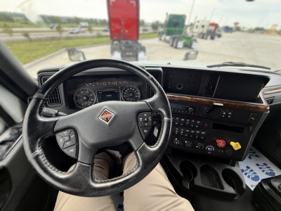 Truck cab interior showing steering wheel, dashboard, and center console of a 2022 International LT625 sleeper truck.