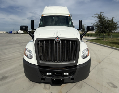 Front view of a white 2022 International LT625 sleeper truck showing grille, bumper, headlights, and badge.