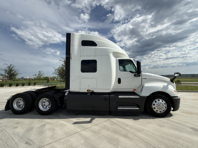 Truck side profile showing a white 2022 International LT625 tractor with sleeper cab, 6x4 configuration, black lower panels, aluminum wheels, and windows along the cab.