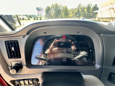 Peterbilt 579 dashboard display screen showing vehicle status and menu options inside cab, with steering column and control stalks visible.