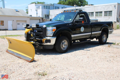 Ford F-250 Super Duty pickup with front plow, black crew cab, side view showing plow attachment.