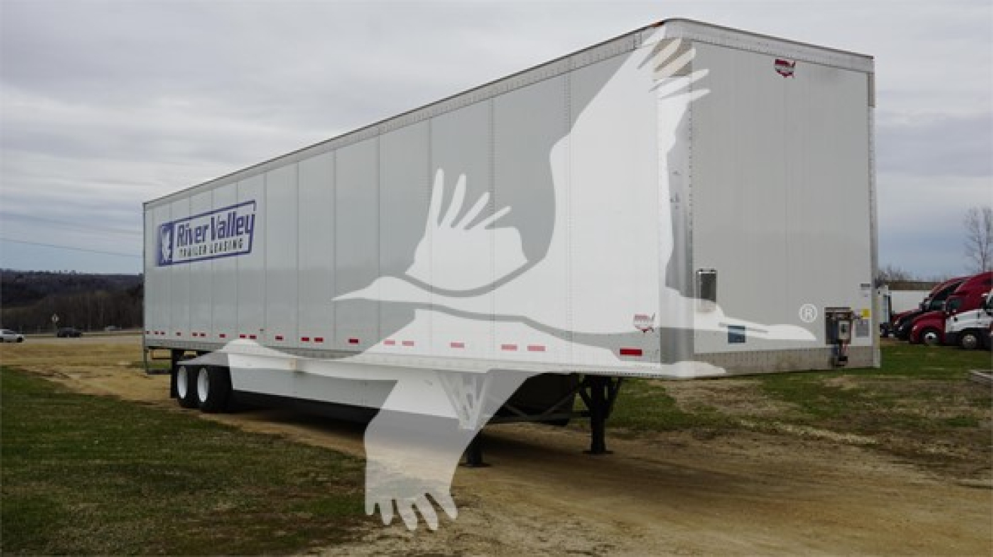 Trailer side showing RiverLallor logo and Duraplate branding with dual-axle flatbed style trailer and white birds watermark.