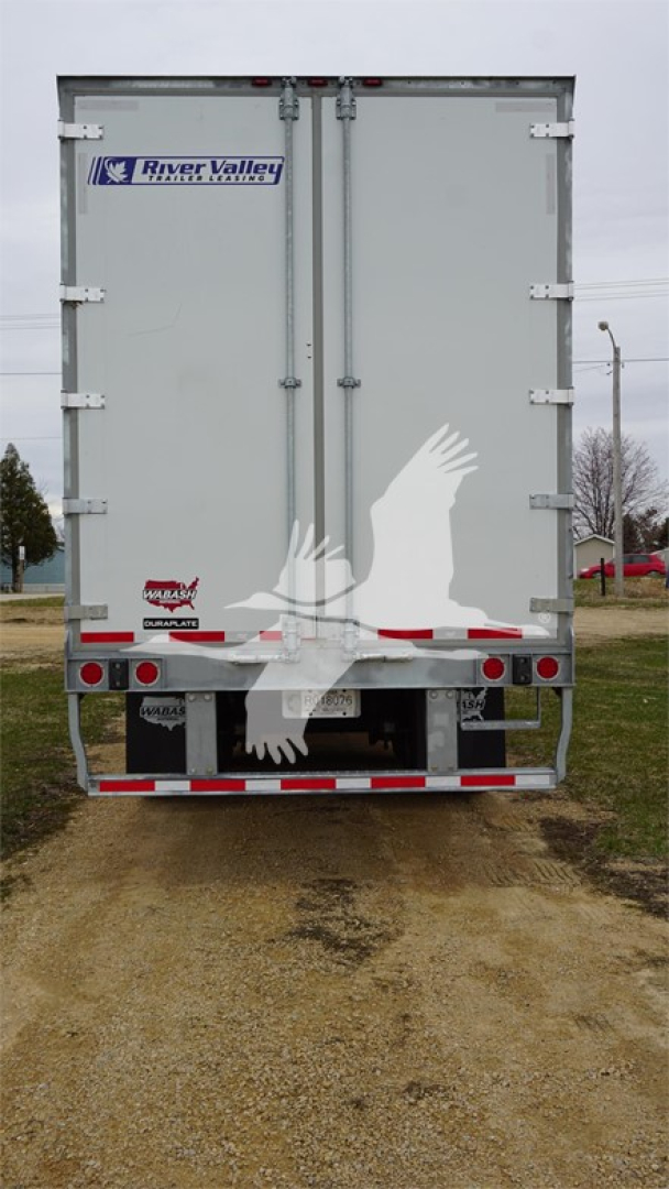 Rear view of a Lange trailer with double doors, River Valley trailer sticker, and reflective red/white safety tape along bumper; two vertical hinges and small decals near lower left.