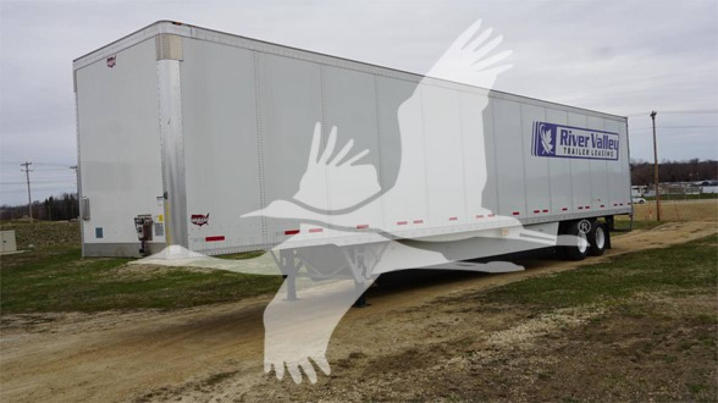  trailer showing River Valley logo on white Wabash Duraplate box trailer with landing gear and dual rear axles.
