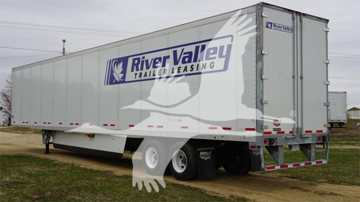 Trailer side view showing River Valley Trailers Leasing logo on Wabash Duraplate trailer with dual rear doors and tandem axles.