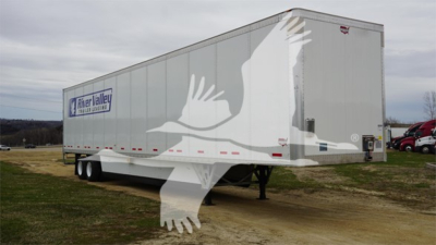 Trailer side showing RiverLallor logo and Duraplate branding with dual-axle flatbed style trailer and white birds watermark.