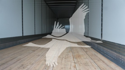 Interior of a used 2023 Wabash Duraplate trailer showing wooden floor and side rails, empty cargo space.