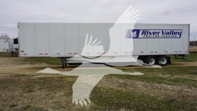 Trailer side showing River Valley Trailer Leasing logo on a white 2023 Wabash Duraplate trailer, dual rear axles, flatbed field setting.