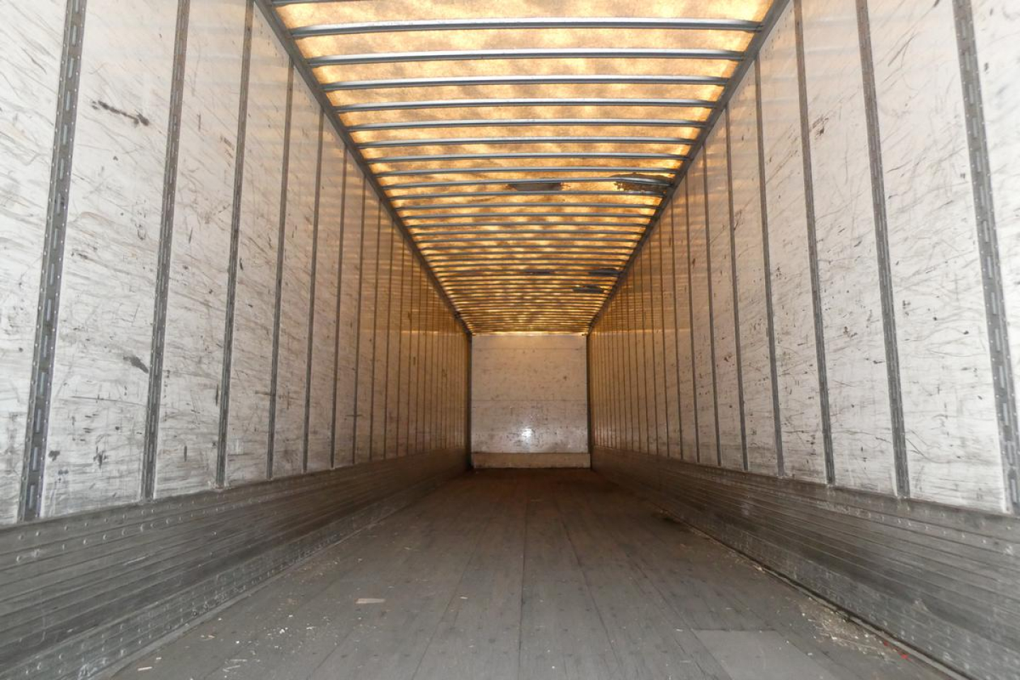 Trailer interior with metal side rails and wooden roof framing; empty cargo space in a Vanguard VXP trailer