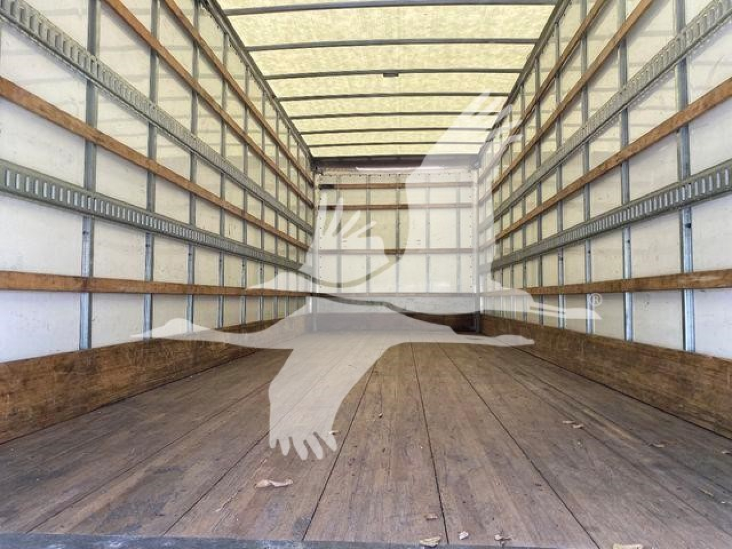 Interior of an empty box truck trailer showing wooden floor and side rails, with a faint watermark logo in the center.