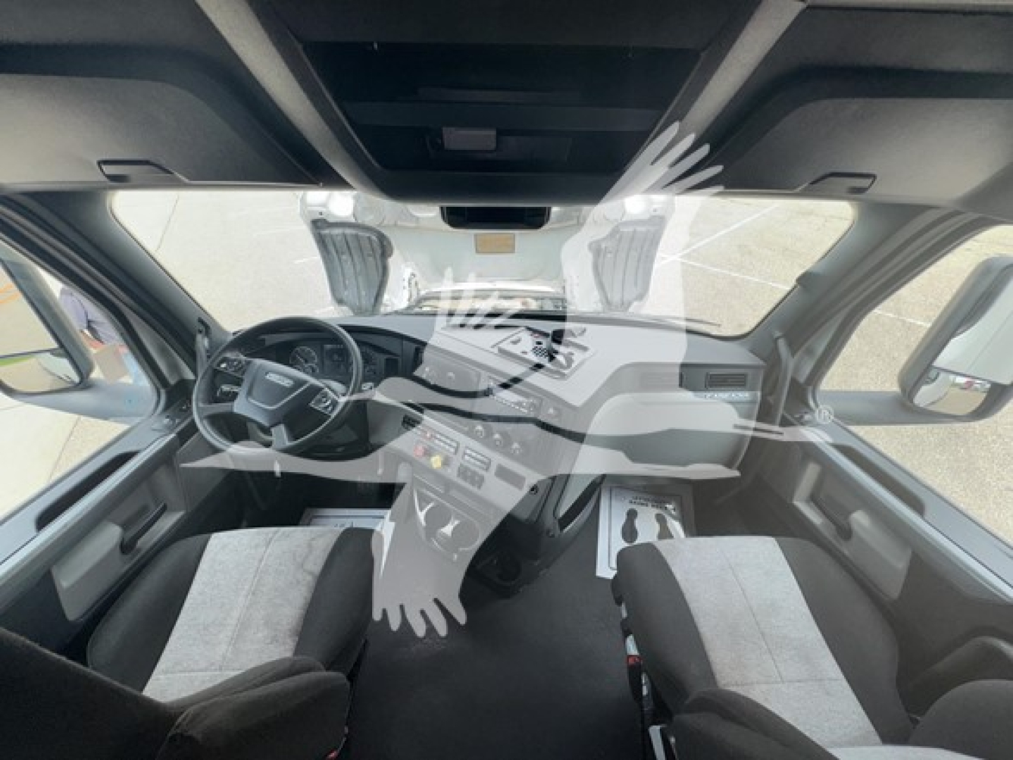Cab interior of a 2022 Freightliner Cascadia 126 conventional sleeper showing steering wheel, dashboard controls, and front seats.