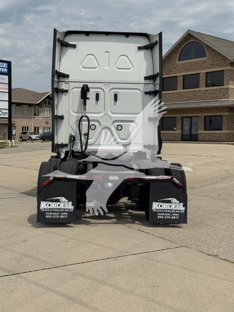 Truck rear view showing tractor cab back doors and rear fenders with Kordell dealership mud flaps and wiring harnesses, Freightliner Cascadia 126 offshore