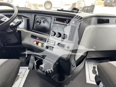 Dashboard view of a 2022 Freightliner Cascadia 126 sleeper. Visible components include steering wheel, instrument panel with gauges, center console with switches, cupholders, and pedal area.