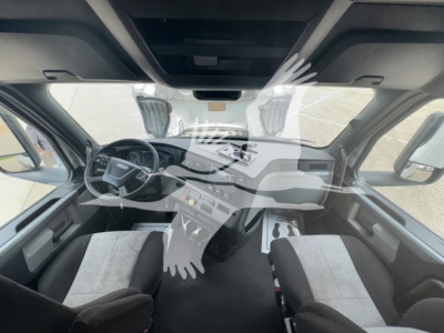 Cab interior of a 2022 Freightliner Cascadia 126 conventional sleeper showing steering wheel, dashboard controls, and front seats.