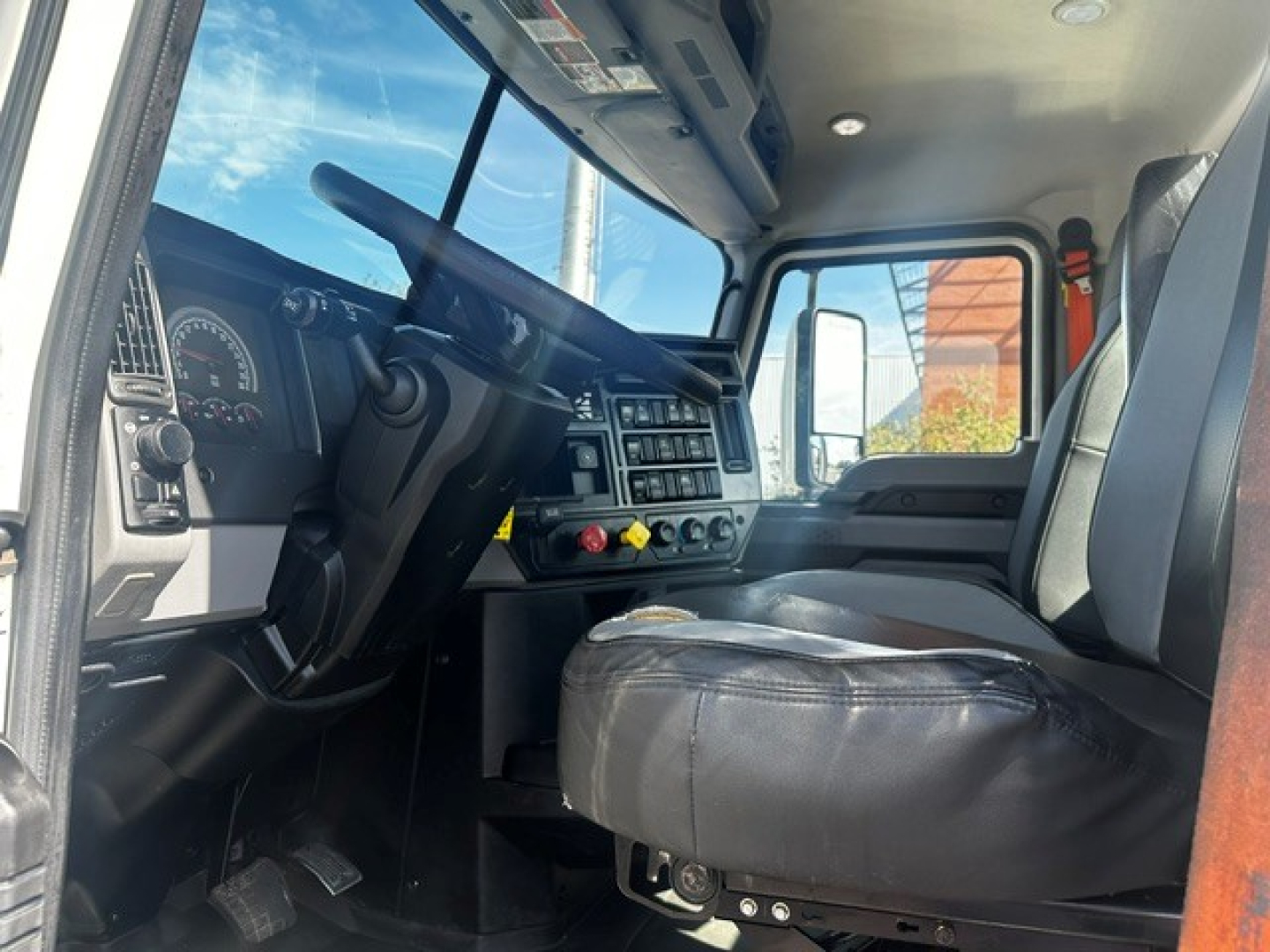 Cab interior of a 2020 Mack PI64T truck showing steering wheel, dashboard with gauges, and driver's seat.