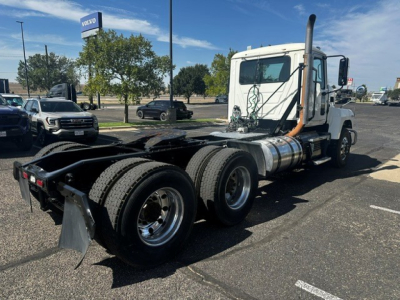 Truck chassis of a 2020 Mack PI64T daycab showing dual rear axles and exposed fifth wheel area.