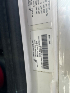 Label with VIN and stock information on truck door jamb: Mack Trucks, VIN 1M1PN3GY7LM005738, Stock No.  SBA3837P, spec tags listing front/rear axle data.