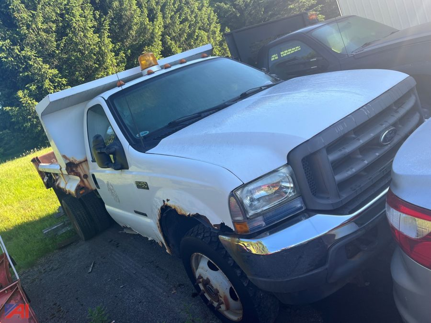 Ford F-450 dump truck in service showing front grille, headlights, and dump bed
