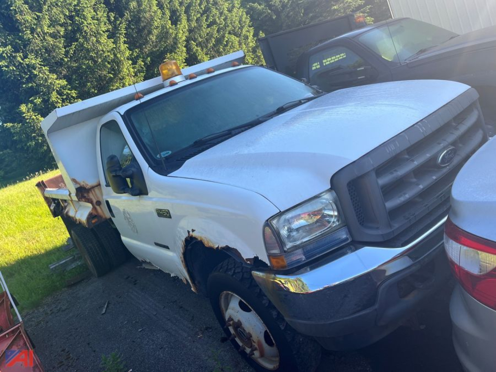 Ford F-450 dump truck in service showing front grille, headlights, and dump bed