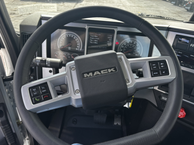 Mack GR64FT steering wheel and dash view showing ergonomic center display and control buttons.