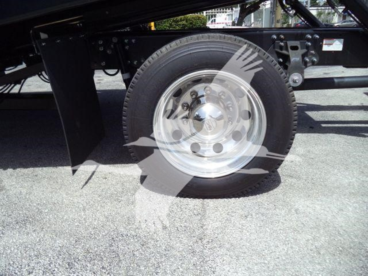 Wheel and suspension area of a 2026 Hino L6 truck showing a single steel wheel and tire with undercarriage components.