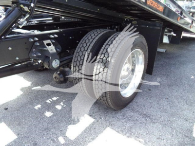 Truck rear dual wheels and undercarriage suspension on a 2026 Hino L6 rollback truck showing dual tires and chassis components.