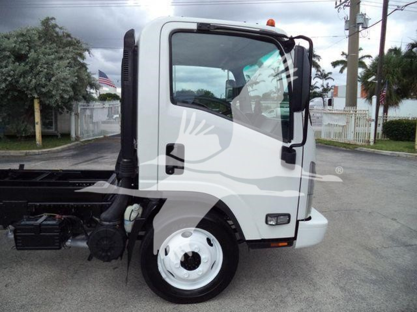 Truck cab side view showing 2017 Chevrolet W4500 dump truck with white cab and black chassis.
