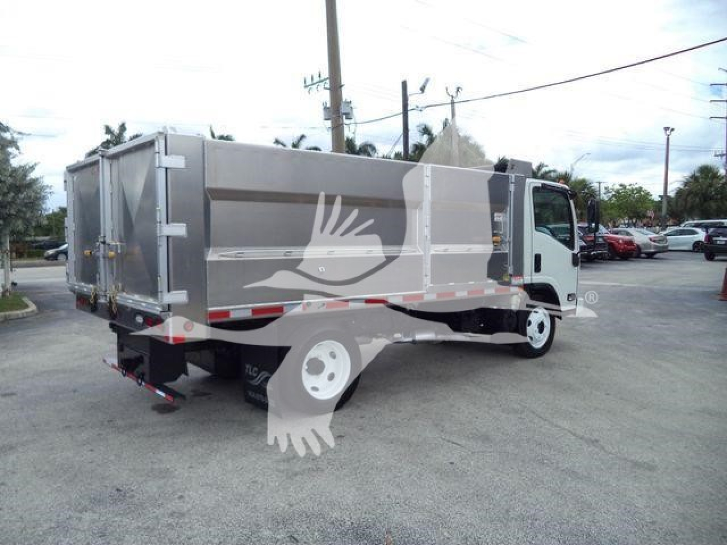 2017 Chevrolet W4500 dump truck rear and side view showing cargo bed and cab in a dealership lot