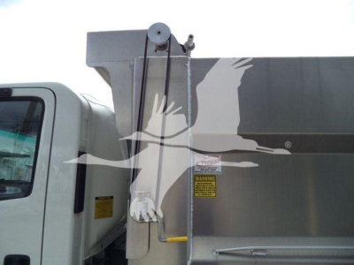 Truck cab and dump body of a 2017 Chevrolet W4500 dump truck showing hydraulic lift and warning label on the side.