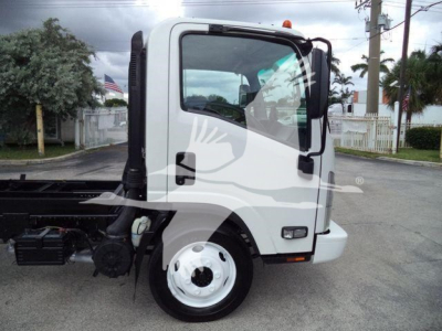 Truck cab side view showing 2017 Chevrolet W4500 dump truck with white cab and black chassis.