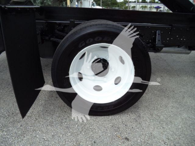 Wheel and chassis of a 2017 Chevrolet W4500 dump truck showing Goodyear tire and white steel wheel, with surrounding frame and fender.