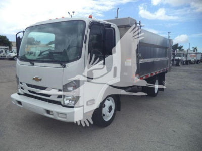 Chevrolet W4500 dump truck with gray cab and black dump bed, side view showing front grille and wheel, used vehicle.