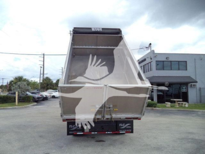 Chevrolet W4500 dump truck bed rear view showing empty cargo box and tailgate, with hydraulic mechanism visible and dealership plates at bumper.