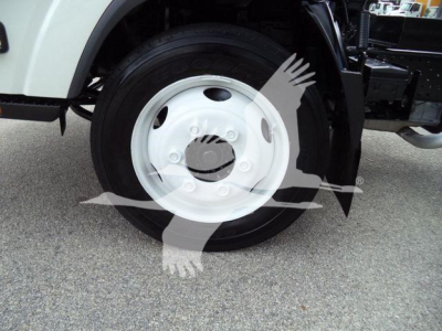 Front wheel and hub of a 2017 Chevrolet W4500 dump truck showing white steel wheel and tire.