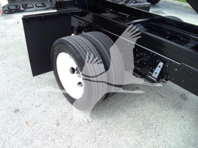 Truck chassis with dual rear wheels and black frame showing wheel and suspension details.