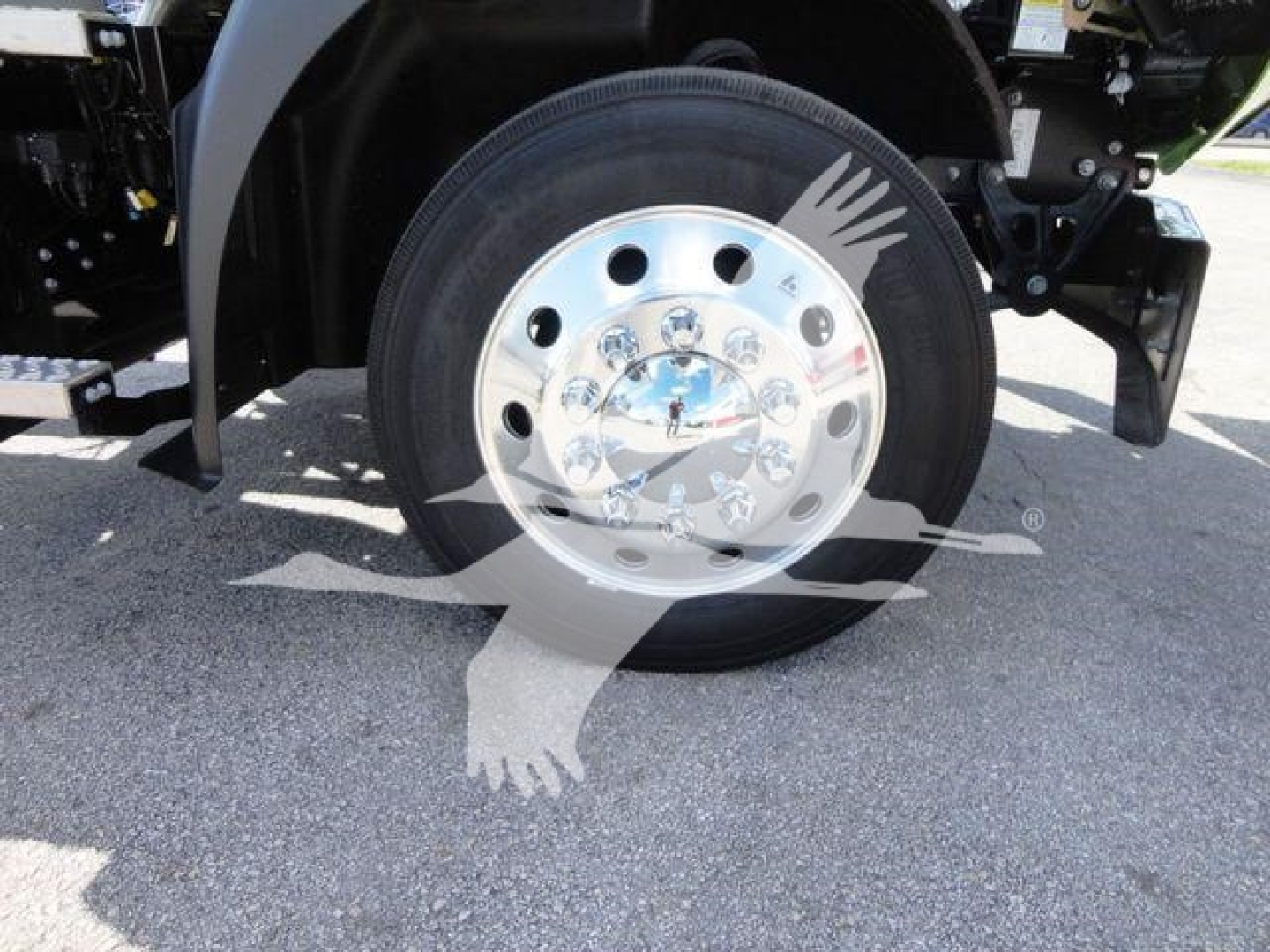 MD6 Mack truck front wheel hub and tire assembly showing chrome center cap and lug nut holes.