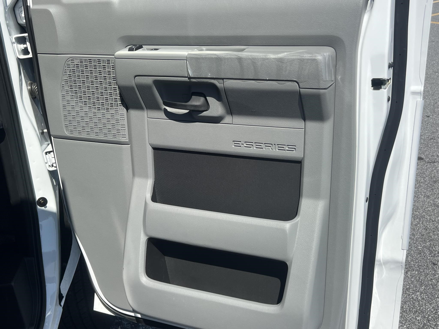 Ford E-Series E-Series cargo van interior door panel showing door handle and storage pockets.
