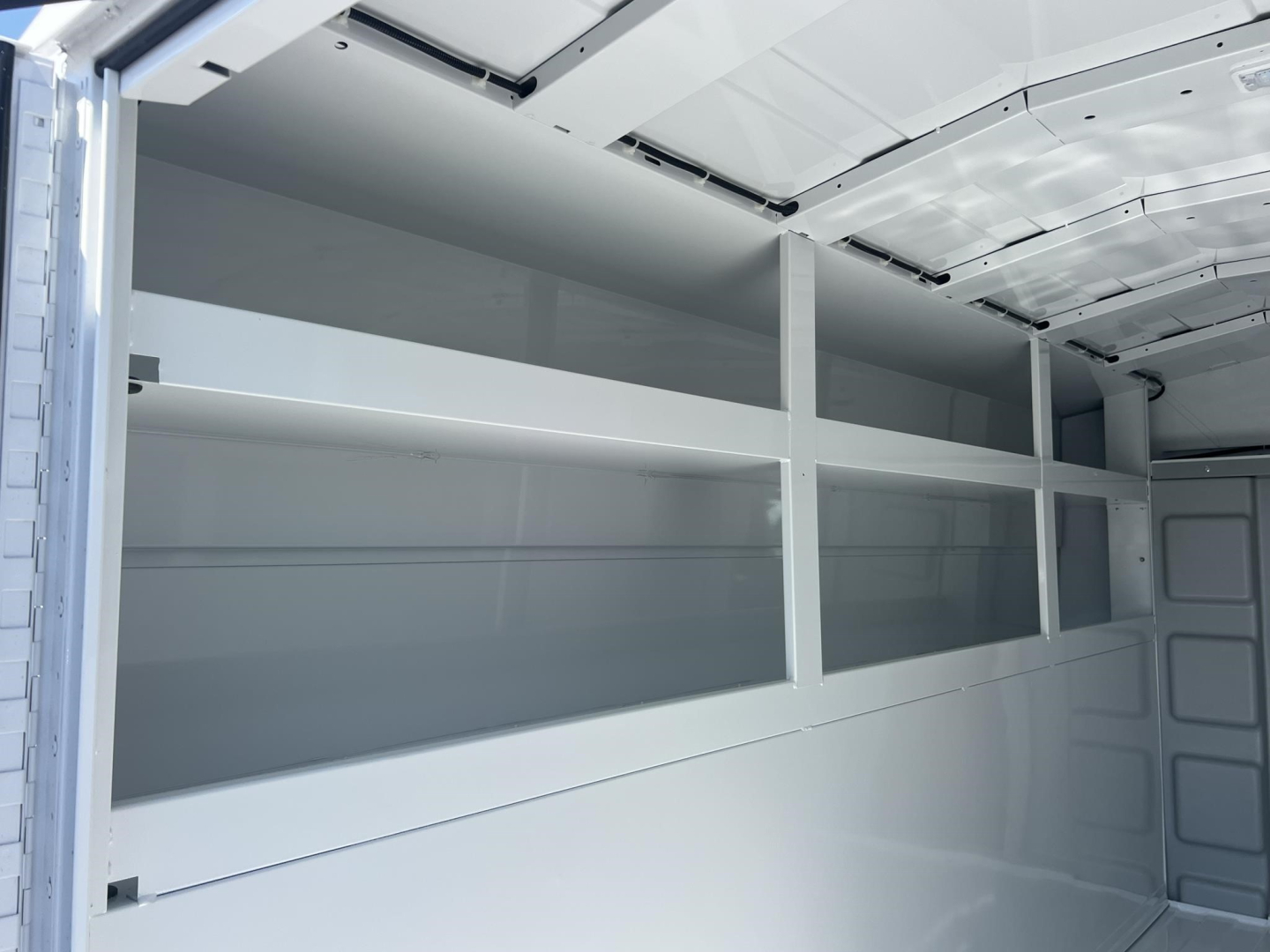 Ford E-350 service/utility van interior shelving in cargo area with multiple metal shelves.