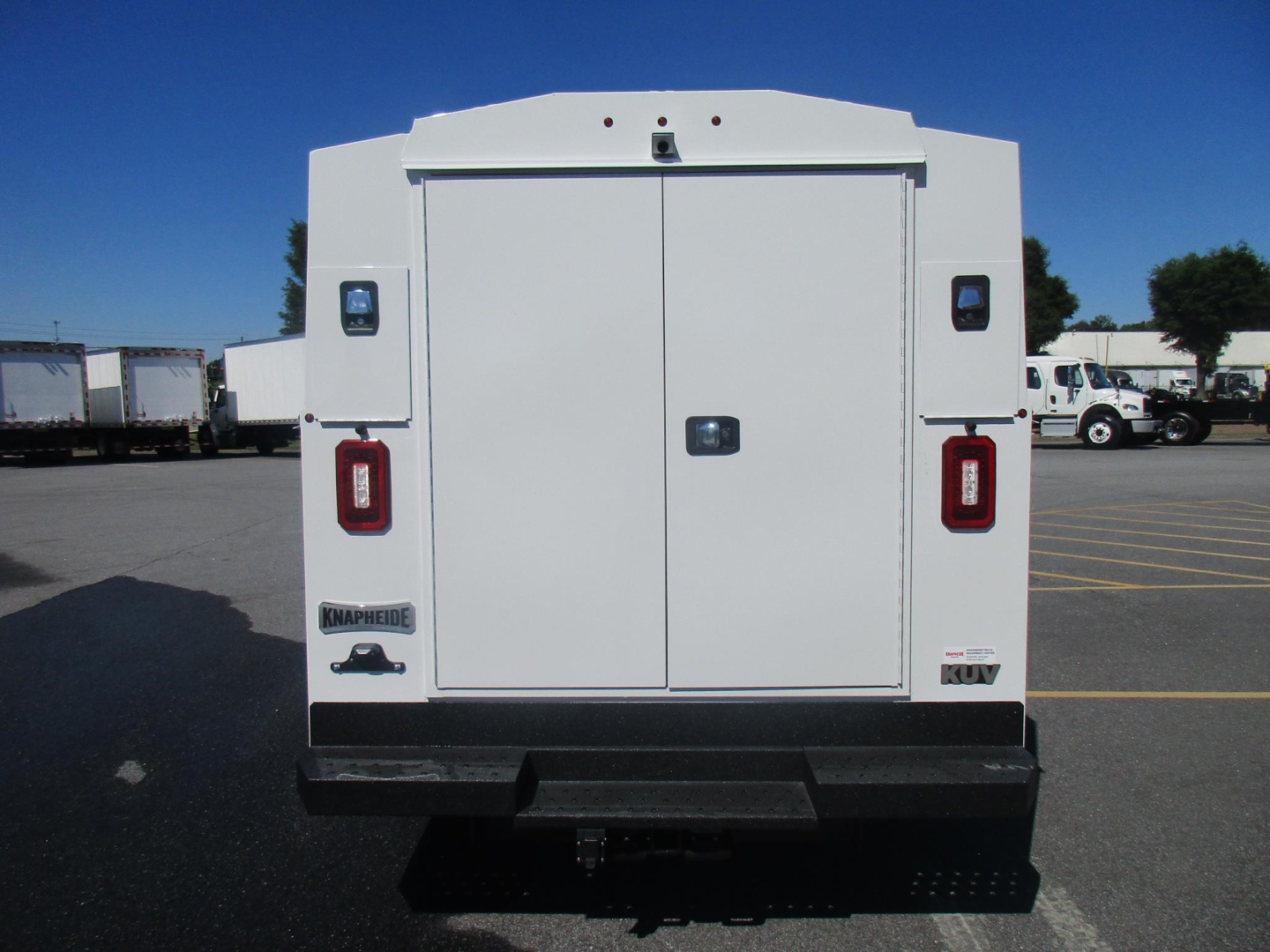 Ford E-350 service utility van rear view showing double doors with HDS storage, taillights, and rear bumper.