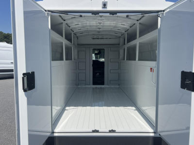 Ford E-350 cargo van rear interior showing empty cargo space with sidewalls and roof beams