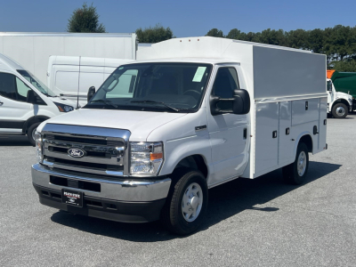 White Ford E-350 service utility van with box cargo area, front grille and headlights visible, VIN 1FDWE3FN3TDD36007 on dealer plate.