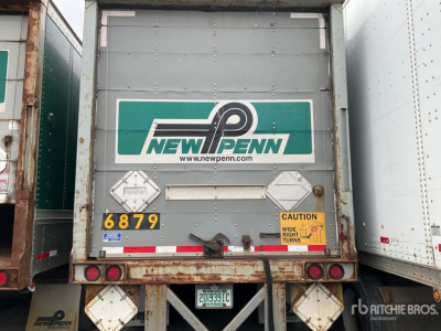 Truck trailer back showing New Penn logo and hazard placards 6879 with bumper reflectors and license plate area.