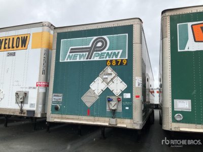 Trailer rear view with New Penn logo, diamond plate and hazard placard on green trailer; other trailers visible on either side.
