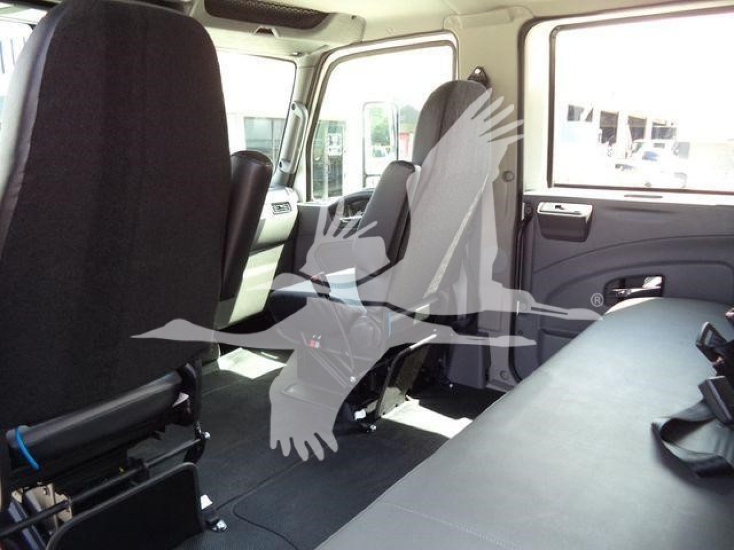 Interior of a new 2027 International MV rollback truck showing front seats, side doors, and rear seating area.